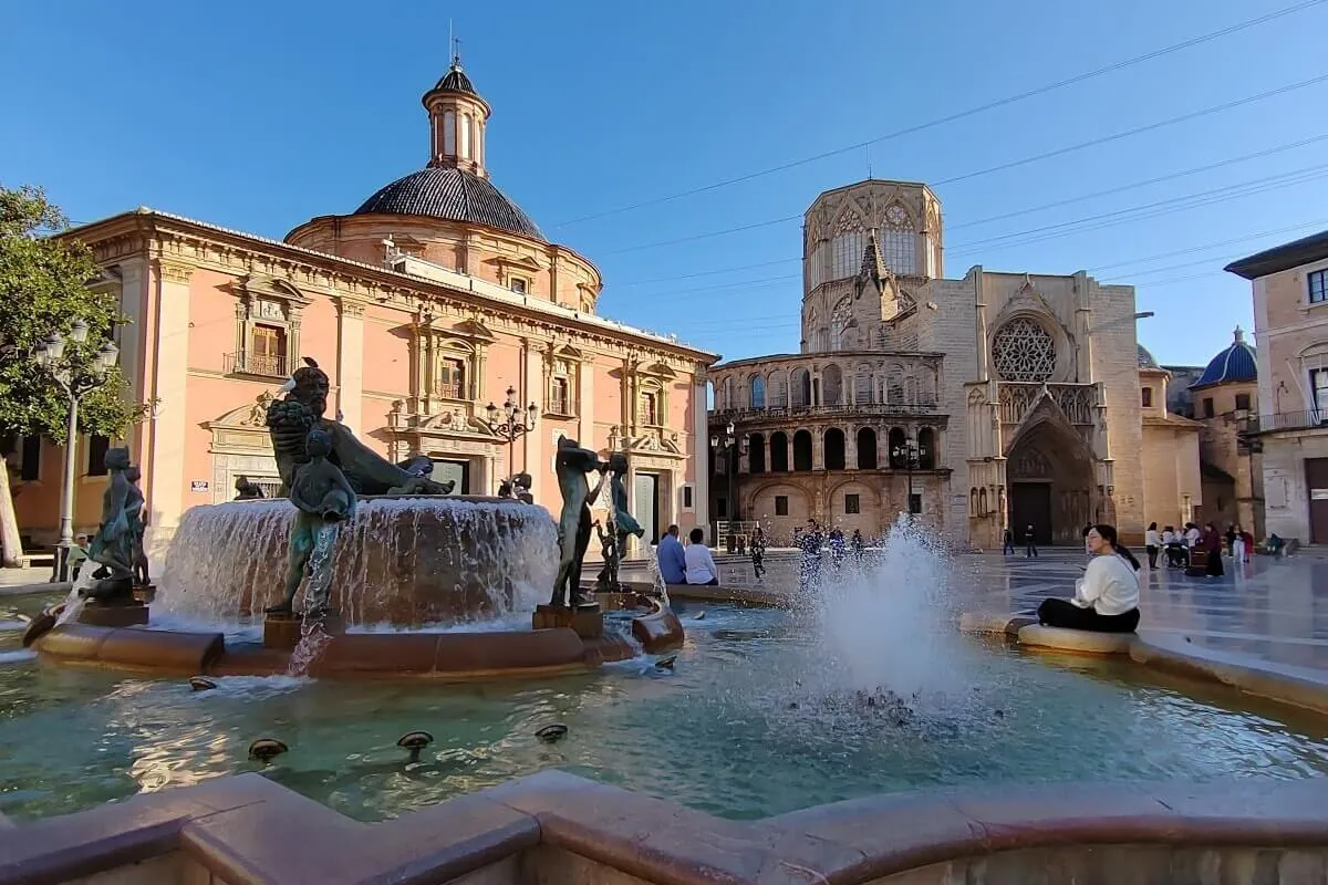 Plaza de la Virgen főtér Valenciában a Turia-szökőkúttal, a Katedrálissal és a Szűzanya-bazilikával – Valencia látnivalók